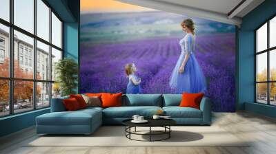 Cute baby in the flowering field of lavender. Wall mural