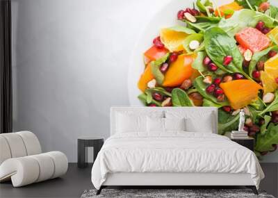 Fresh salad with fruits and greens on white background top view with space for text. Healthy food. Wall mural