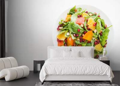 Fresh salad with fruits and greens on white wooden background top view with space for text. Healthy food. Wall mural