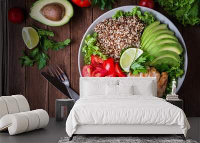 healthy salad bowl with quinoa, tomatoes, chicken, avocado, lime and mixed greens (lettuce, parsley) Wall mural