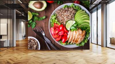 healthy salad bowl with quinoa, tomatoes, chicken, avocado, lime and mixed greens (lettuce, parsley) Wall mural