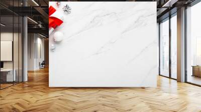 Merry Christmas and Happy Holidays greeting card, frame, banner. New Year. Noel. Christmas gifts and red decor on white marble background top view. Winter xmas holiday theme. Flat lay Wall mural