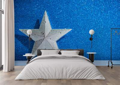 Silver star on abstract blue glitter holiday background. Winter xmas holidays. Christmas. Space for text. Wall mural