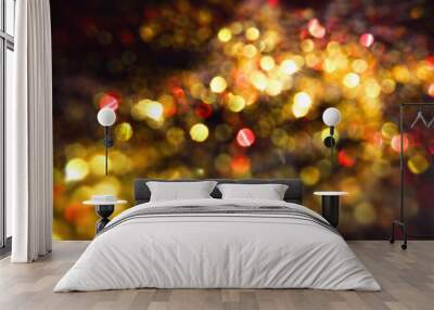 Christmas golden lights on black night  background,  bright glow bokeh. Wall mural