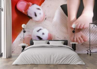 Close up bare foot in the morning at home, relaxing. Funny fluffy panda slippers. Comfort aesthetics style Wall mural