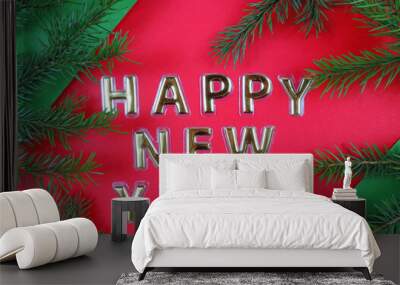 Happy New Year  gold letters on a red green background and natural fir branches of a Christmas tree    Happy New Year Concept. Flat Lay. Wall mural