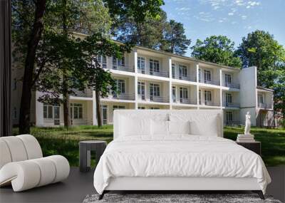 A typical three-story building of a sanatorium near Moscow with balconies on the river bank Wall mural