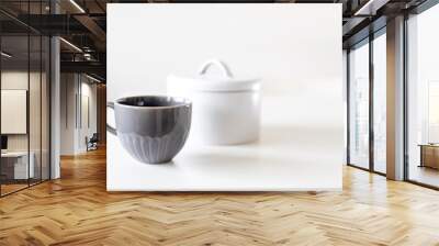 Two porcelain grey cups are on the white table. Wall mural