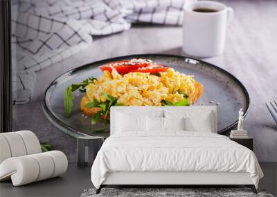 Appetizing toast with scrambled egg, tomato and sesame seeds on a plate Wall mural