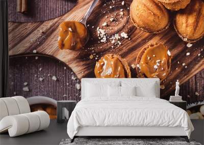 Close up of walnut shaped cookies filled with boiled condensed milk on a board top view Wall mural