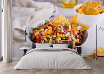 Mexican vegetable salad cowboy caviar and nachos in a bowl on the table Wall mural