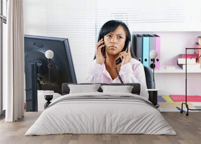 black businesswoman using two phones at desk Wall mural