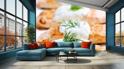 Cooked salmon fillets with dill sauce on white plate Wall mural