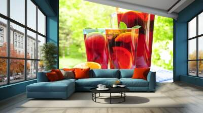 Fruit punch in pitcher and glasses Wall mural