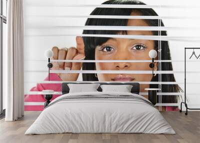 Woman looking through venetian blinds Wall mural