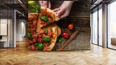 Appetizing pizza. Pizza with ham, mushrooms and tomatoes on a wooden background Wall mural