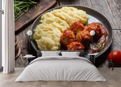 Mashed potatoes with meatballs in tomato sauce in a bowl Wall mural