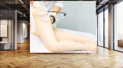 Cavitation rf body treatment. Female ultra sound lipo machine. Spa contouring. Doctor hands Wall mural