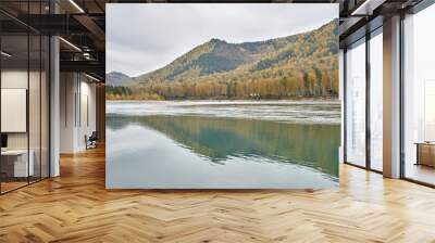 Tranquil autumn lake scene with reflected mountains and vibrant forest in serene landscape. Wall mural