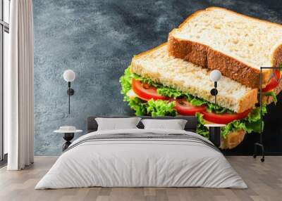 Fresh lettuce tomato sandwich on dark background Wall mural