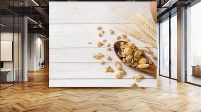 Dry Breakfast of oat flakes, granules and nuts. Muesli on a light table in a wooden spoon and ears. Copy space Wall mural