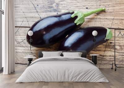 Fresh eggplant on wooden background with copy space. Wall mural