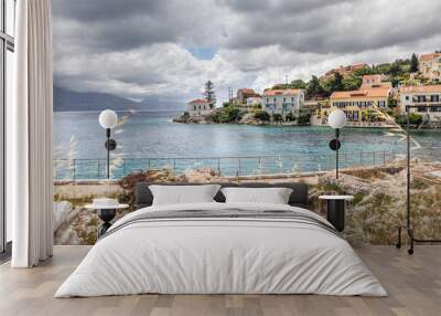 Fiskardo village on the Ionian Island of Kefalonia Greece, summer vacation destination, cloudy sky and beautiful landscape scenery Wall mural