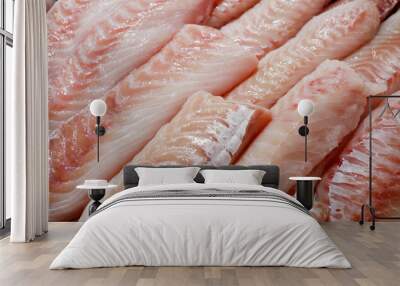 Seabass, hamour, grouper fish, sea bass fillet many pieces sliced piled bulk in fish market. Wall mural