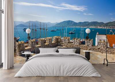 The view from the Turkish Fort of the fortress of Marmaris Bay, the promenade and the surrounding area with the mountains and yachts Wall mural