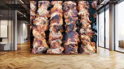 frying pork on a skewer over a brazier. turning meat over coals. appetizing shish kebab. delicious b Wall mural