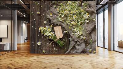 Close-up photo of camomile on canvas. Top view on vintage wood background Wall mural