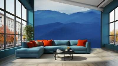 Peaceful blue nature background with foggy Bucegi mountains in Carpathians seen from Cota 2000, Sinaia resort, Romania Wall mural