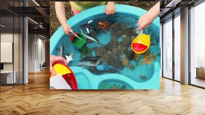 Children Playing with Boats and Sea Creature/Ocean Life Toys in a Water Table. Science/STEM activity being enjoyed by children in a daycare/child care/home school setting. Wall mural