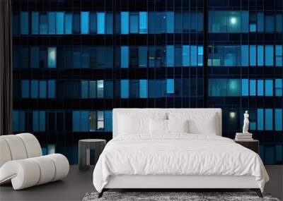 Seamless skyscraper facade with blue tinted windows and blinds at night. Modern abstract office building background texture with glowing lights against dark black exterior walls Wall mural