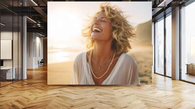 Smiling mature woman at the beach, natural lifestyle, enjoying the sunny weather on beach coast Wall mural