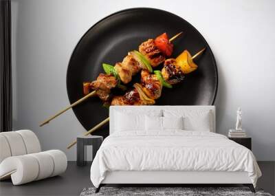 Yakitori on black plate with white background isolated Wall mural