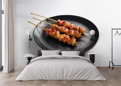 Yakitori on black plate with white background isolated Wall mural