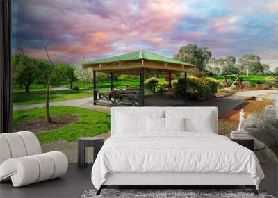 beautiful Children’s park playground in Suburban Melbourne Victoria Australia. Lovely green grass and nice sunset colours in the sky Wall mural