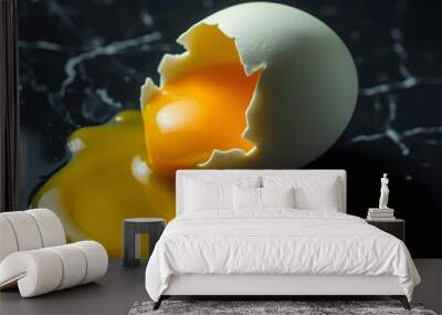 A cracked egg with a vibrant yellow yolk spilling onto a glossy black marble countertop creating te with ai Wall mural