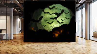 A mysterious Halloween bat background capturing bats emerging from a dark cave, illuminated by a faint glow from glowing mushrooms create with ai Wall mural