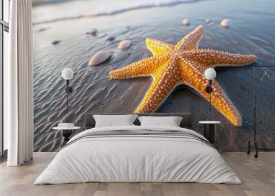 A bright starfish lies on smooth sand, surrounded by tiny shells, with the calm ocean waves softly lapping at the shore in the background Wall mural