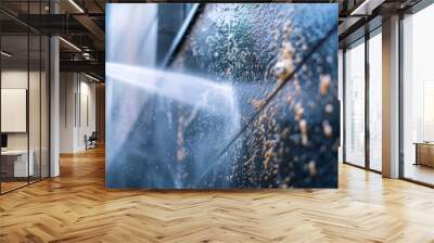 A close-up photo of a pressure washer blasting away dirt and grime from the exterior of a building Wall mural