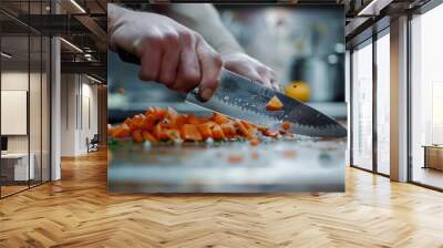 A closeup of a persons hands chopping carrots with a chefs knife on a wooden cutting board Wall mural