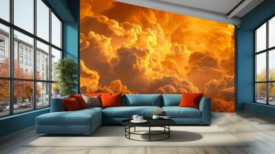 A closeup of billowing clouds in shades of yellow and orange, illuminated by the golden hues of the setting sun Wall mural