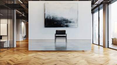 A minimalistic room showcases a black chair placed centrally against a white wall, complemented by a large abstract painting, emphasizing clean lines and modern aesthetics Wall mural