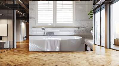 A sleek, modern bathroom featuring white marble tiles, a spacious tub with a towel draped over the edge, and a sleek, white sink with copy space on the right side Wall mural