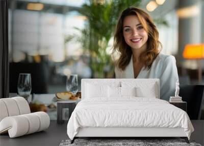 A woman smiles contently while seated at a table, enjoying a beautifully plated meal in a luxurious airport lounge Wall mural