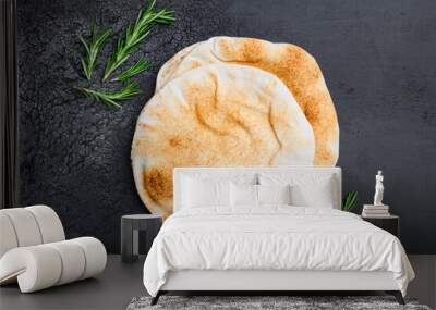 Pita bread on kitchen set, on black dark stone table background, top view flat lay, with copy space for text Wall mural