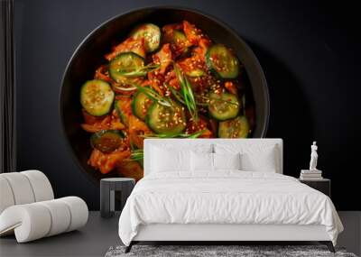 Savor the rich and spicy flavors of gourmet Oi-kimchi, a Korean cucumber salad sprinkled with sesame, presented in a contemporary black bowl Wall mural