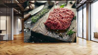 Side angle shot of raw ground beef spread out on a dark wooden cutting board Wall mural